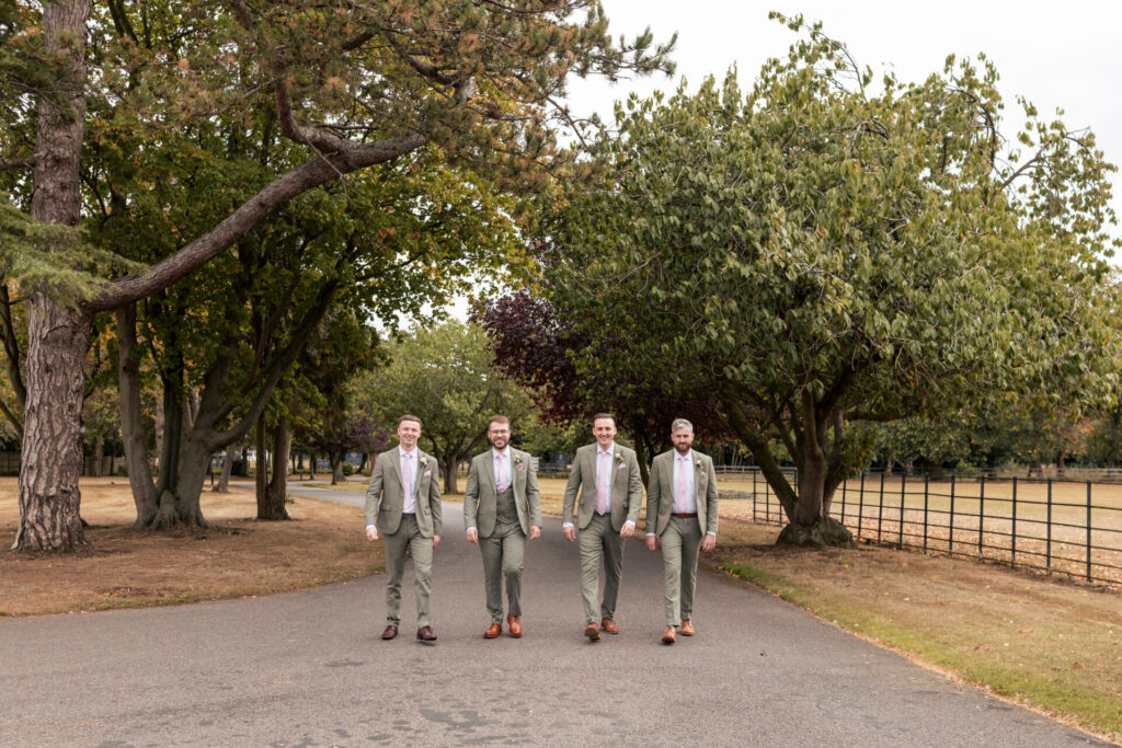 Groom and groomsmen walking down the drive for a personalised fun wedding