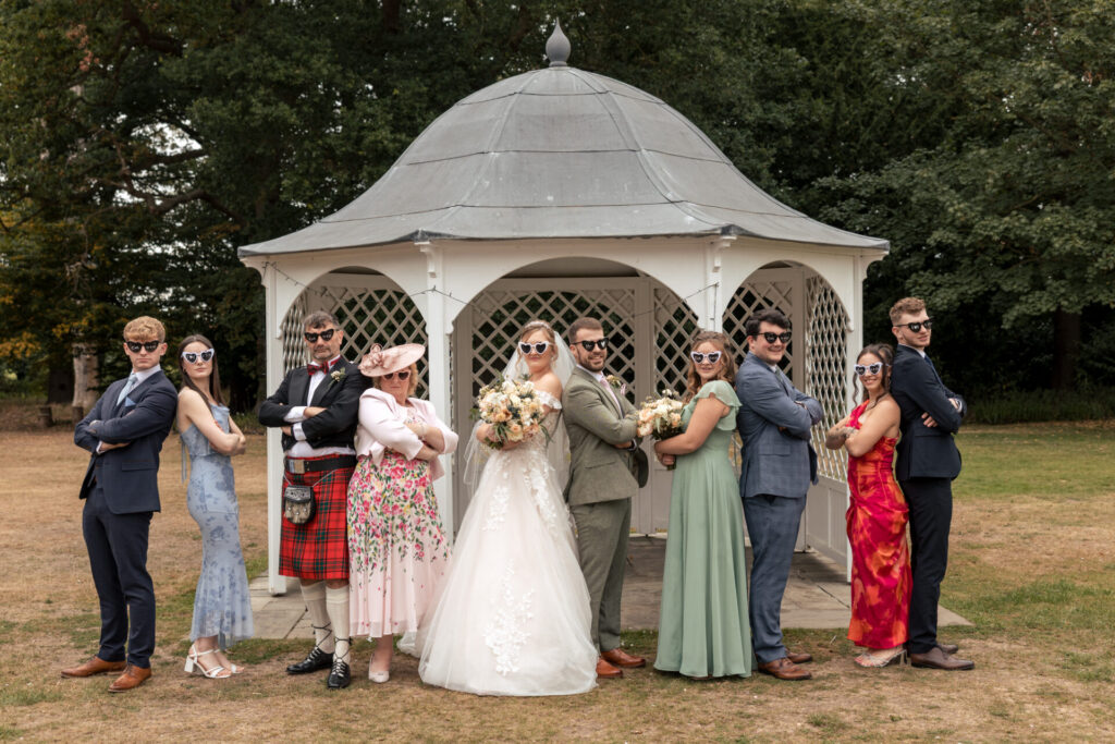 Group photos outside with sunglasses for a personalised fun wedding