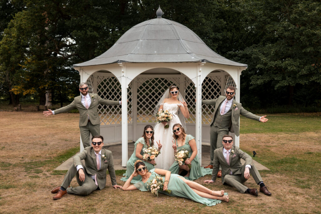 Wedding party outside the gazebo wearing sunglasses for a personalised fun wedding